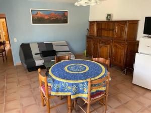 a room with a table and chairs and a bed at Mas du Prescondu in Mirabel-aux-Baronnies