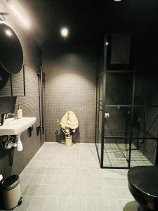 a bathroom with a shower and a sink and a toilet at Brukshotellet in Ekeby +21 photos