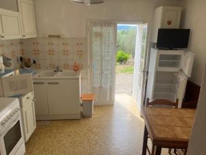 a kitchen with a sink and a door to a yard at Mas du Prescondu in Mirabel-aux-Baronnies +6 photos