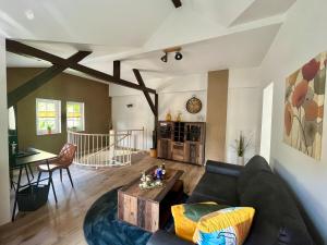 a living room with a couch and a table at Ferienhaus Villa Frosch in Meiningen