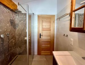 a bathroom with a glass shower and a sink at Ferienwohnungen Angerer Kederlehen in Berchtesgaden