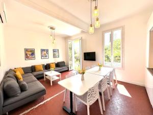 a living room with a couch and a table at Villa Lila in Nice