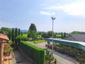 a view of a building with plants and a street at Agriturismo Il Vivaio in Bergamo