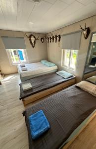 a room with two beds and two trunks at Stāķi in Alūksne