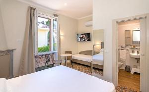 a hotel room with a bed and a bathroom at Villa Gioietta in Marina di Massa