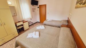Postel nebo postele na pokoji v ubytování Hotel Arno