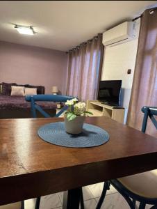 a room with a table with a vase of flowers on it at Вила Николета in Sveti Vlas