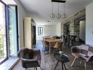 a living room with a table and chairs at A Bella Scusa in Bastelica