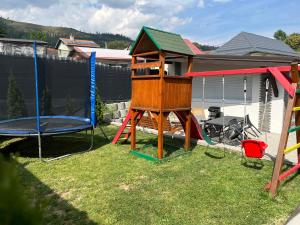 a yard with a playground with a play structure at Ubytovanie MI - TATRY in Kravany