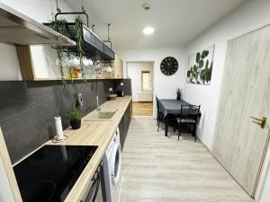 a kitchen with a counter and a dining room at SZE Business Apartman in Győr