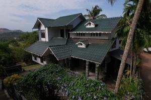 an aerial view of a house with green roofs at Casita Greens in Kondotti