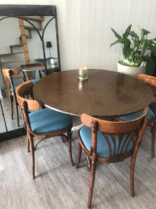 a wooden table and chairs with a table and a table and chairs at Au près de tout in Neuvecelle