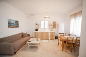 a living room with a couch and a table at Bagiaderra in Panormos