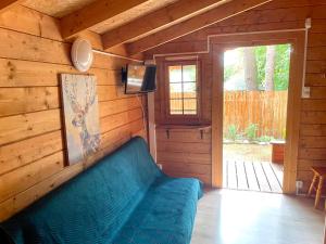 ポッドンビエにあるLeśne Zaciszeのリビングルーム(青いソファ付)