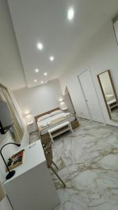 a room with a marble floor and two mirrors at Morgana Sea in Catania