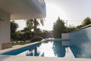 a swimming pool in the backyard of a house at Luxury heated pool Villa in Lagonissi