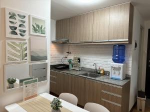 a kitchen with a sink and a counter top at Lian's Haven at Arezzo Place Davao in Davao City