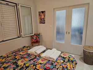 a bedroom with a bed with two towels on it at Guarantee to make you say wow! in Athens
