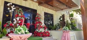 a display of red and white flowers in a building at The Lumber Hotel and Resort in Virac