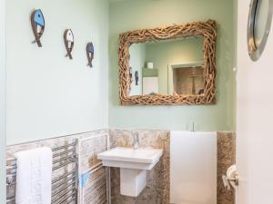a bathroom with a sink and a mirror at Pass the Keys The Pontoon in Southend-on-Sea +36 photos