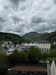 a view of a town with mountains in the background at Appartement à la montagne in Mont-Dore