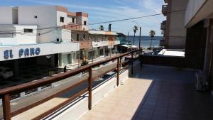 a balcony of a building with the ocean in the background at Hotel Centro in Piriápolis