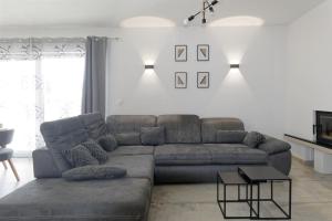 a living room with a couch and a table at Villa Matthias by Rent Istria in Ližnjan
