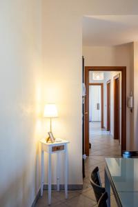 a room with a table with a lamp on it at La Mansarda del Viandante in Castelbelforte +57 photos