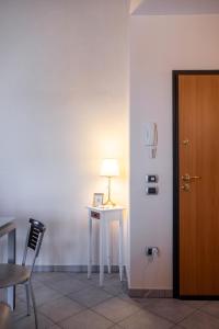 a room with a table and a lamp next to a door at La Mansarda del Viandante in Castelbelforte +57 photos
