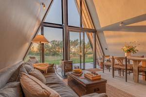 a living room with a couch and a table at Wilder Retreats - A Frame Cabins in Haverfordwest