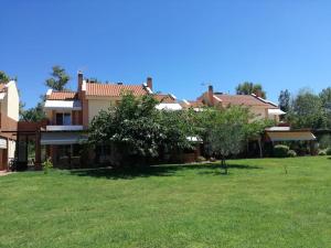 a house with a green yard in front of it at Artemis Villa in Metókhion Konstamonítou