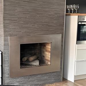 a fireplace with a stone wall at Chalet Benajarafe Beach Malaga in Benajarafe