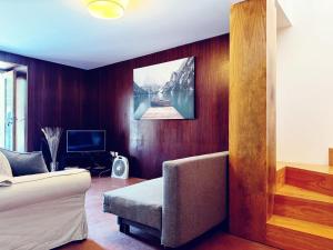 a living room with a couch and a television at Quinta Vale da Prata in Celorico da Beira