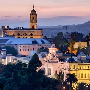 a city skyline at night with a clock tower at Chalet Benajarafe Beach Malaga in Benajarafe