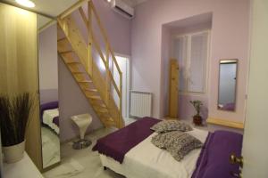 a bedroom with a bed and a spiral staircase at Oceania in Genoa