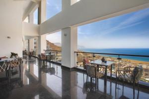 a dining room with a view of the ocean at Tolip Resort El Galala Hills in Ain Sokhna