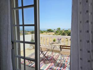 a view from a window of a balcony with a table at Sunshine, casa de campo e praia, estilo e conforto, espaço e privacidade, perfeita para as suas férias em Olhão in Moncarapacho