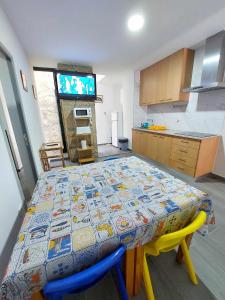 a kitchen with a table with a patterned table cloth on it at Historic Downtown in Vila Real +11 photos