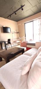 a hotel room with two beds and a table at Aze's Garden suites - Kalkan, Kaş in Kaş