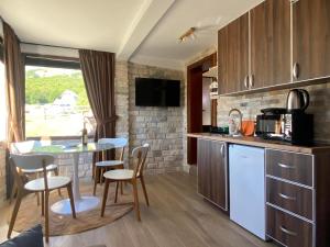 a kitchen and dining room with a table and chairs at Wolf pit in Žabljak