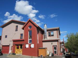 a red brick building with a clock on the front of it at Aurora Bayside Inn in Yellowknife