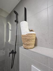 a basket of towels on a shelf in a bathroom at Lendas Apartments & Rooms in Baška Voda +120 photos