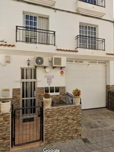 a white house with a garage and a building at APAR MARI 2c in Las Lagunas
