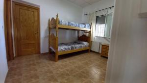 a room with two bunk beds and a door at Casa Rural Entreolivos in Baena