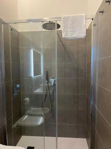 a bathroom with a shower with a glass door at Le Finestre Veneris in Portovenere +62 photos