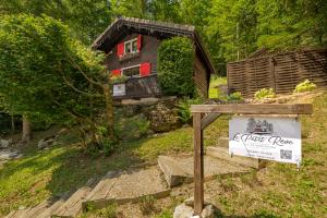 a small house with a sign in front of it at Le Petit Rêve - Lac de Montriond in Montriond +30 photos