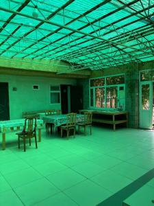 Tamchy"Bilim" Guest House的大房间设有乒乓球桌和椅子