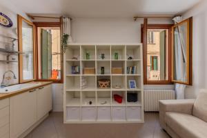 a kitchen with white cabinets and a window at Art & Culture Biennale - Venezia Sweet Stay in Venice
