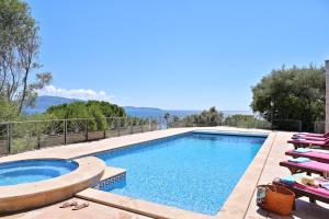 a swimming pool with lounge chairs next to a swimming pool at Résidence Capicciolo Villa A CIGALA in Olmeto