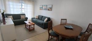 a living room with a couch and a table at O fogar de Sara in O Grove